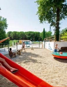 a group of children playing on a playground at Mobil home proche Fréjus - Camping 4 étoiles in Puget-sur-Argens