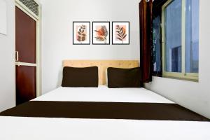 Un pat sau paturi într-o cameră la Super Hotel O Indian Hotel