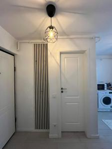 a room with a white door and a microwave at Spania Studio in Craiova