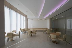 a dining room with tables and chairs in a building at Casa Haven Retreat in Dubai +41 photos