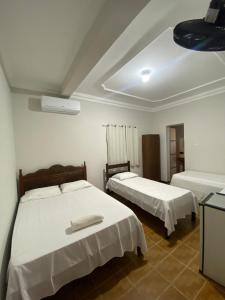 Ένα ή περισσότερα κρεβάτια σε δωμάτιο στο Hotel Minas Brasil