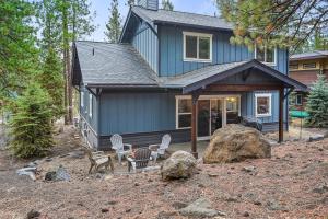 a blue house with chairs in front of it at Trails End Retreat in Bend