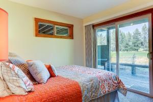 a bedroom with a bed and a large window at 3 Spyglass in Sunriver
