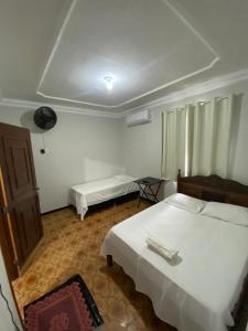 Ένα ή περισσότερα κρεβάτια σε δωμάτιο στο Hotel Minas Brasil +1 φωτογραφίες