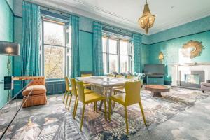 a dining room with green walls and a table and chairs at 12A Queens Gardens, St Andrews in St. Andrews