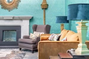 a living room with a couch and a chair at 12A Queens Gardens, St Andrews in St. Andrews