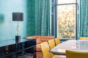 a dining room with a table and yellow chairs at 12A Queens Gardens, St Andrews in St. Andrews +23 photos