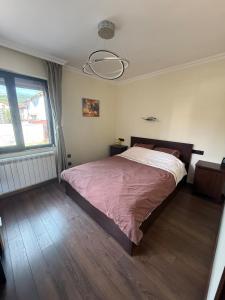 a bedroom with a bed and a large window at Pasarel House in Pasarel
