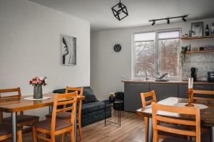 a kitchen and living room with a table and a couch at Guest house ''Viktoria'' in Simitli