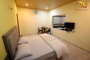 a hospital room with a bed and a small table at The Lyca Resorts in Jog Falls