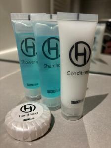 two bottles of hand sanitizer and two cups on a counter at Loftbude in Hürth +9 photos