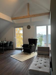 a living room with a couch and a table at Loftbude in Hürth