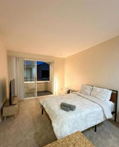 ein Schlafzimmer mit einem großen Bett und einem großen Fenster in der Unterkunft Marina Del Rey Sunrise - Pool & Gym & Sauna & Cinema in Fullerton