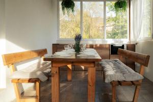 a dining room table with two chairs and a window at Guest house ''Viktoria'' in Simitli +6 photos
