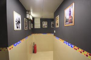 a bathroom with a shower with colorful tiles on the wall at Timehouse Hong Kong Hostel Group in Hong Kong