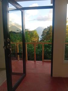 an open door to a balcony with a view at Hostel Casa escondida in Santa Cruz La Laguna