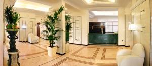 a lobby with potted plants in a building at Hotel Terme Marine Leopoldo II TERME & SPA in Marina di Grosseto +144 photos