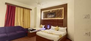 a living room with a couch and a blue couch at Hotel classic inn in Hyderabad