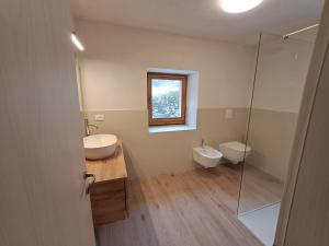 a bathroom with two sinks and a glass shower at La Casa di Elvira-Primo Piano in Piaia