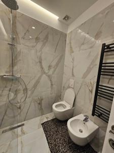 a bathroom with a toilet and a shower and a sink at Tirana Apartment KDK in Tirana +72 photos