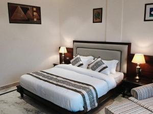 a bedroom with a large bed and two lamps at The Himalayan Residency in Duttnager