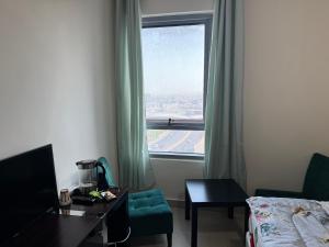 a hotel room with a bed and a window at Helsa in Sharjah