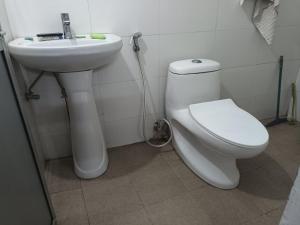 a bathroom with a toilet and a sink at Dzükou Guest House in Kohīma