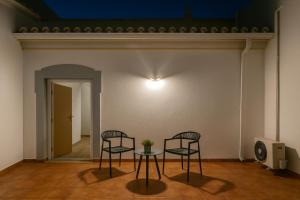 two chairs and a table in a room at Full private 180sqm Villa - Terrace Jacuzzi - 200m Beach & Sea View in Albufeira