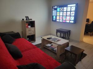 a living room with a red couch and a table at Aki Land in Mladenovac +18 photos