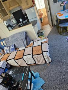 a bedroom with a bed and a mirror at Sandys Secret Corner Centrally Heated Southview SKEGNESS in Winthorpe +42 photos
