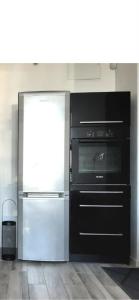 a kitchen with a refrigerator and a stove at Komfort Noclegi in Blizne Łaszczyńskiego