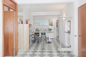 a kitchen with a black and white checkered floor at Polanesi Sea View - Garden - AC - Free Park - Super Wi Fi in Sori