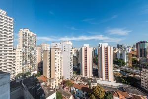 a city skyline with tall white buildings at Apartamento Luxuoso 62 - São João in Sao Paulo