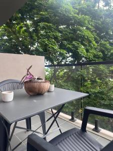 a table and a chair on a patio with a window at Suite Sky and Sea in Flic-en-Flac
