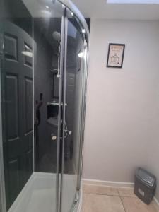 a shower with a glass door in a bathroom at Tyneside Apartments 5 Minutes From City Centre in Newcastle upon Tyne