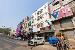 a white car parked on the side of a city street at Trevon Inn Karol Bagh, New Delhi in New Delhi
