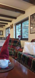a gnome sitting on a table in a living room at Casa AyA Colibita in Colibiţa