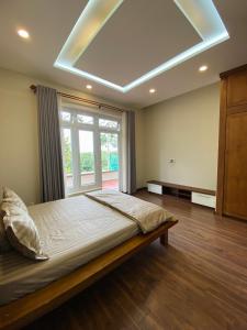 Ένα ή περισσότερα κρεβάτια σε δωμάτιο στο Xù Gia Trang