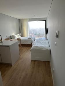 Postel nebo postele na pokoji v ubytování New Douro Tower 203 + 13 fotografií