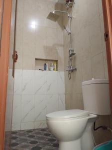 a bathroom with a toilet and a shower at Homestay Tata in Bugisan +16 photos