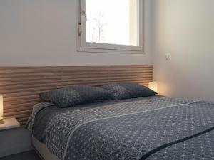 勒格兰阿伯尔热芒L'échappée Belle的一间卧室，配有一张床、两个枕头和一扇窗户