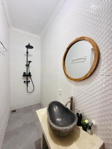 a bathroom with a black sink and a mirror at Talvista Kintamani Villa in Kintamani