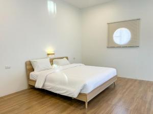 Ένα ή περισσότερα κρεβάτια σε δωμάτιο στο Nakai Resort Sakon Nakhon