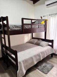 two bunk beds in a room with a bed at Casa Mas in Escobal