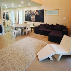 a living room with a couch and a table at The other side of the CLT semi-detached house, with a separate SPA in Lahti