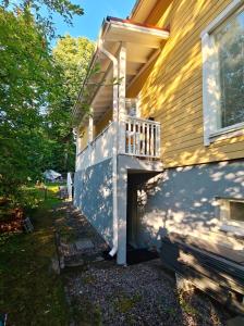a balcony on the side of a house at The other side of the CLT semi-detached house, with a separate SPA in Lahti