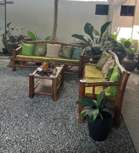 Zimmer mit 2 Sofas und einem Tisch mit Pflanzen in der Unterkunft Residencia Helen in Katungal