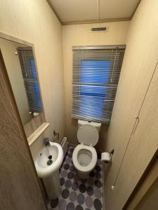 Kinmel Bay3 bedroom Lyons Oakfield Towyn pets welcome的带马桶和水槽的小浴室