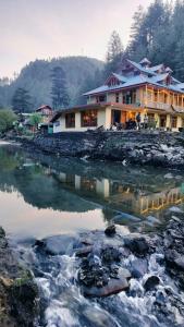a house on the shore of a river at Shiva Valley Riverside in Jibhi