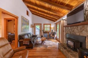 a living room with a fireplace and a tv at Knotty Pine in West Jefferson
